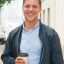 cheerful-guy-enjoying-outdoor-coffee-break-scaled.jpg